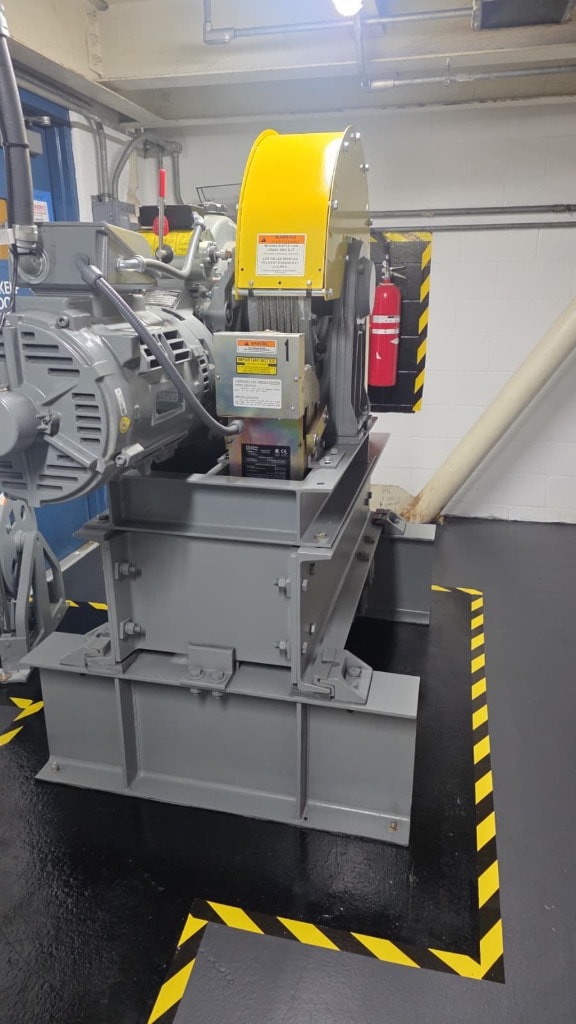 Elevator machine room — motor, drive sheave, and cable reel equipment